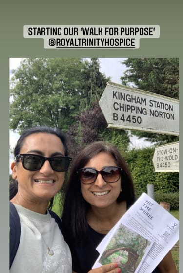 Instagram story scrrenshot of 2 women smiling, one holding a map in front of a Chipping Norton road sign
