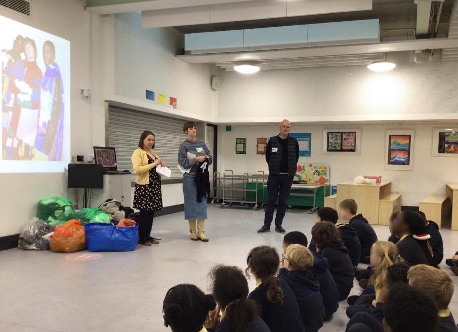 3 members of the Trinity retail staff giving a talk to a Year 6 form