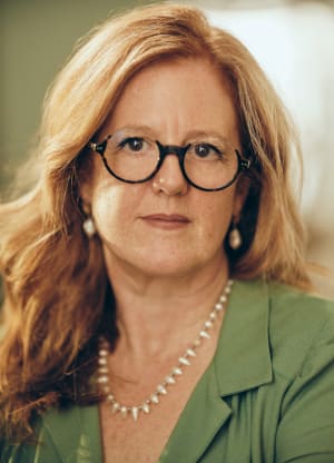 Woman wearing glasses and a green shirt