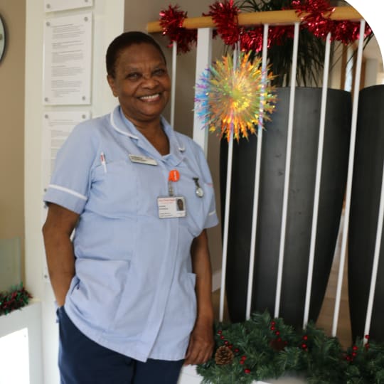 A nurse standing smiling