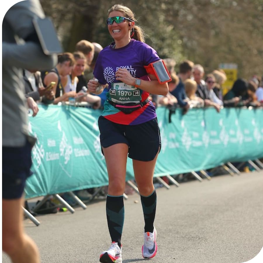 Anna running a race in a Royal Trinity Hospice purple t-shirt