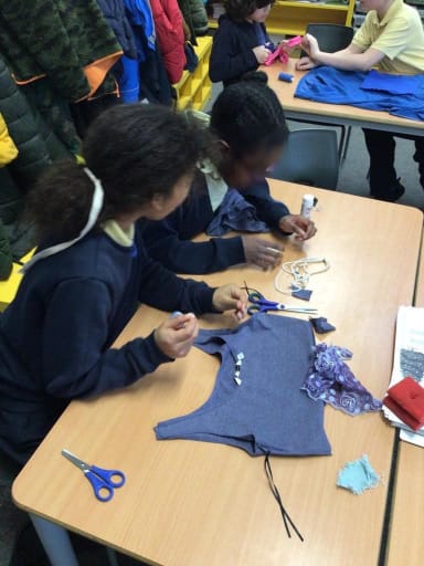 Two Year 6 students cutting and sewing a top together