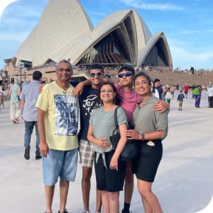 A group of people stood in front of the Sydney Opera house